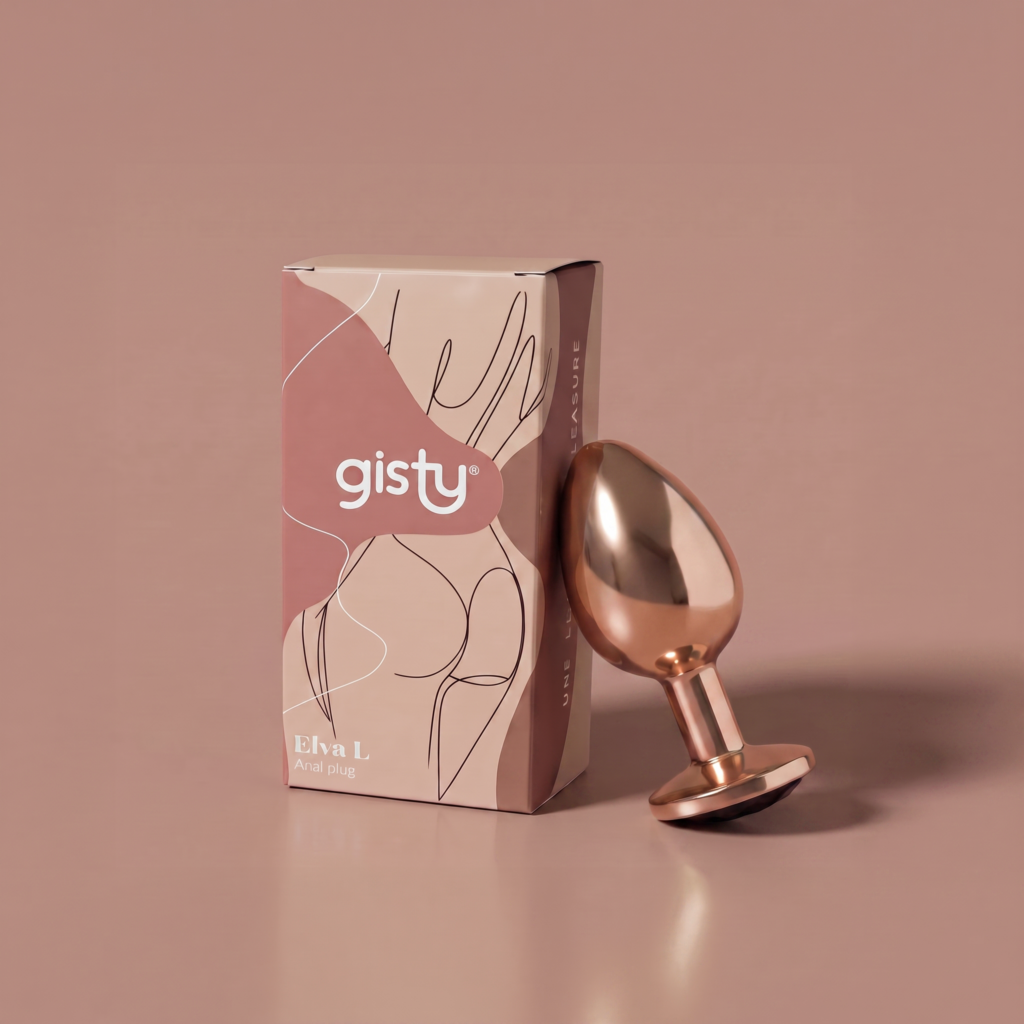 Elva L — metalowy korek analny w kolorze rose gold, widok z boku, obok pudełko gisty