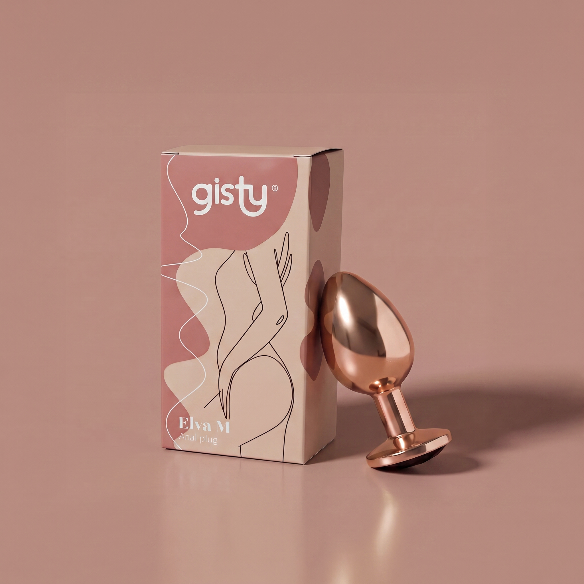Elva M — metalowy korek analny w kolorze rose gold, widok z boku, obok pudełko gisty